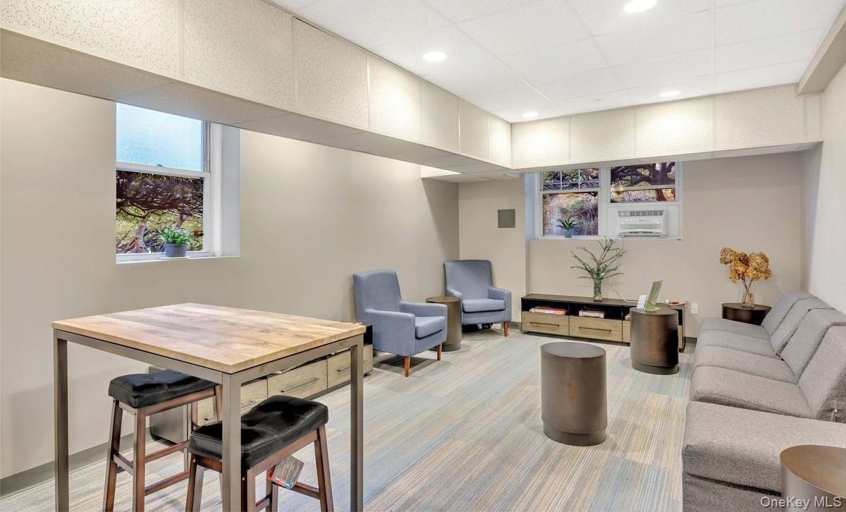 77-14 113th Street, Unit 4S Queens, NY 11375 - Photo 29 of 40 a living room with furniture a flat screen tv and a table