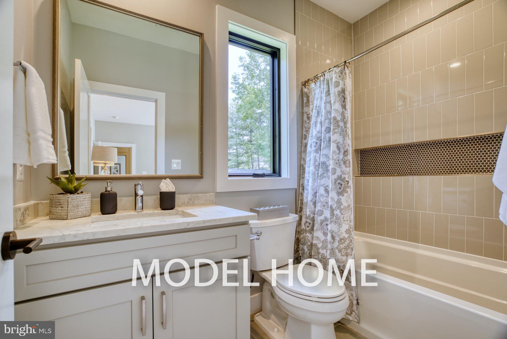 911 Desale Street Southwest Vienna, VA 22180 - Photo 38 of 59 a bathroom with a sink a toilet and a mirror