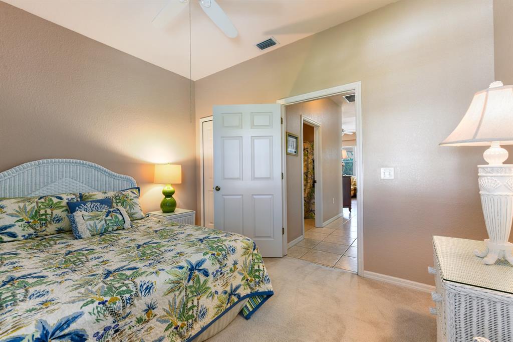 3181 Matecumbe Key Road, Unit 28 Punta Gorda, FL 33955 - Photo 15 of 39 a bedroom with a bed and a lamp