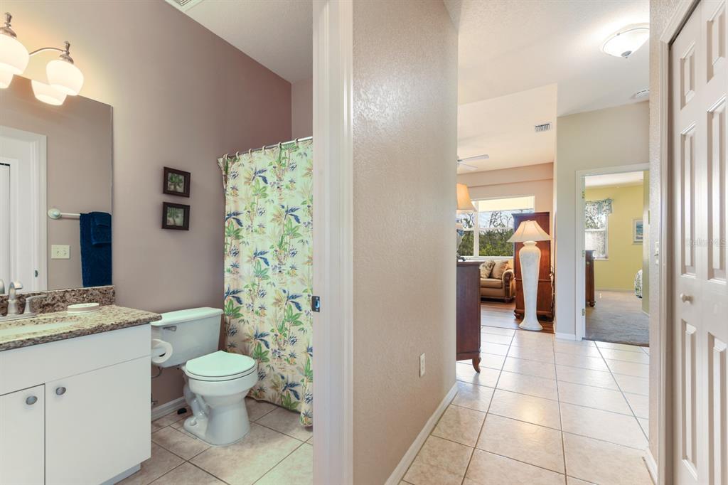3181 Matecumbe Key Road, Unit 28 Punta Gorda, FL 33955 - Photo 16 of 39 a bathroom with a granite countertop sink a toilet a mirror and shower