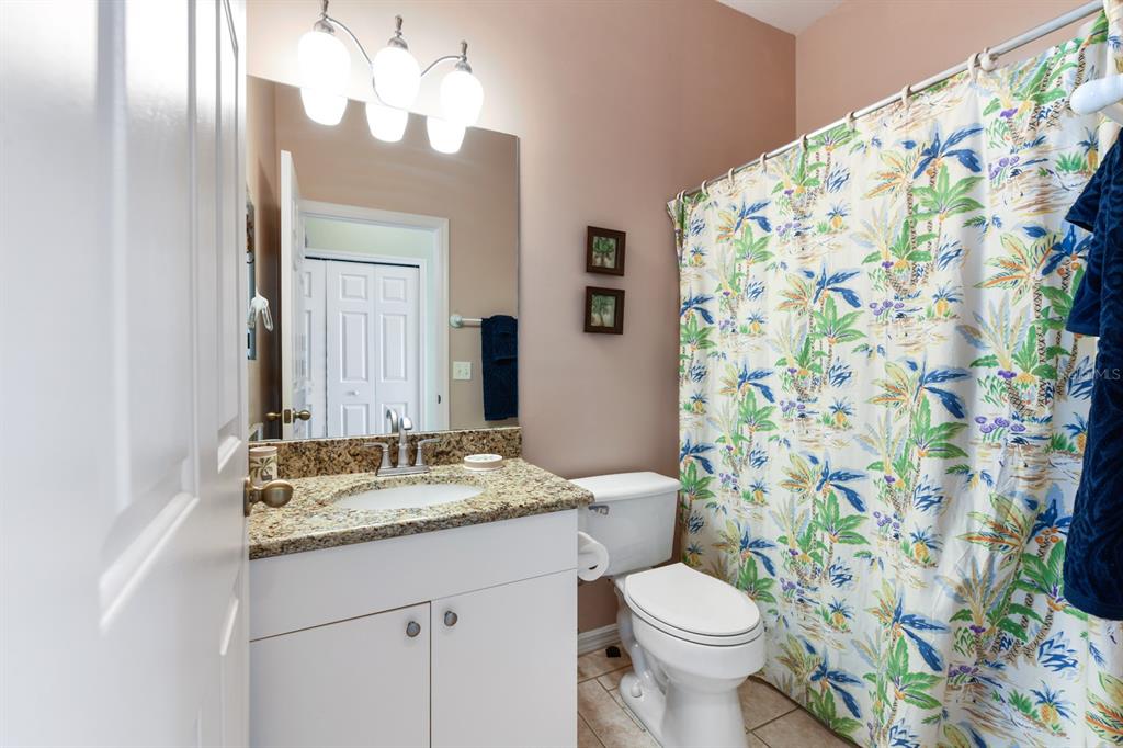 3181 Matecumbe Key Road, Unit 28 Punta Gorda, FL 33955 - Photo 18 of 39 a bathroom with a granite countertop toilet sink and mirror