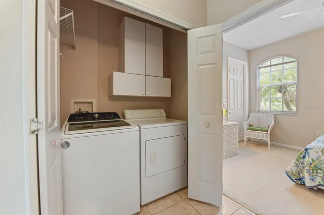 a utility room with closet dryer and washer