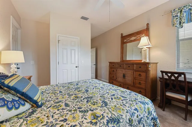 a bedroom with a bed and a dresser in it