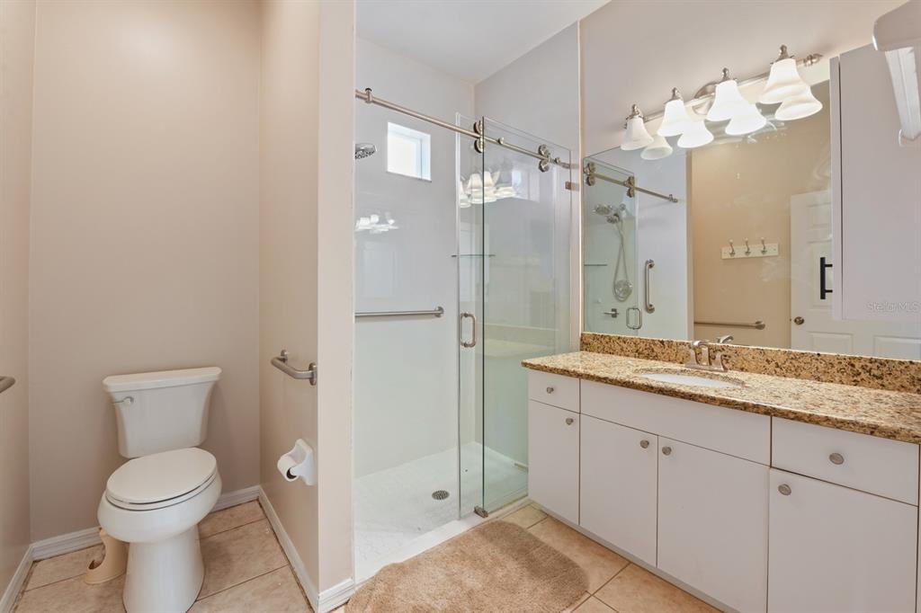 3181 Matecumbe Key Road, Unit 28 Punta Gorda, FL 33955 - Photo 25 of 39 a spacious bathroom with a granite countertop sink a toilet and a shower