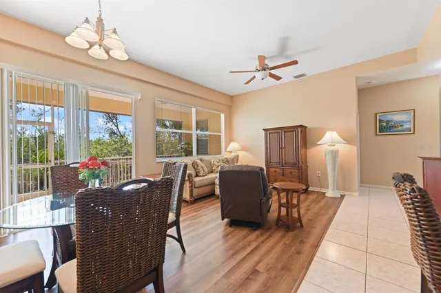 a dining room with furniture a chandelier and window