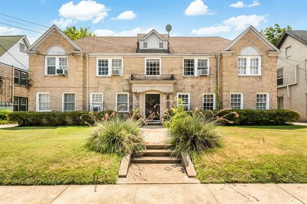 a front view of a house with garden