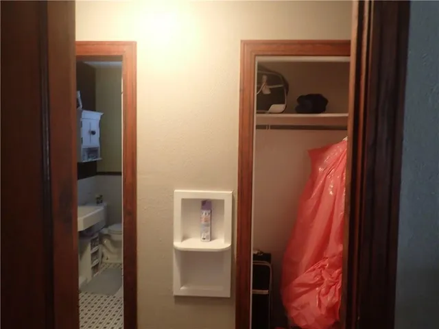 a view of hallway with toilet