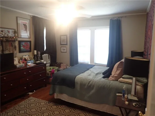 a bedroom with a bed and a mirror on dresser