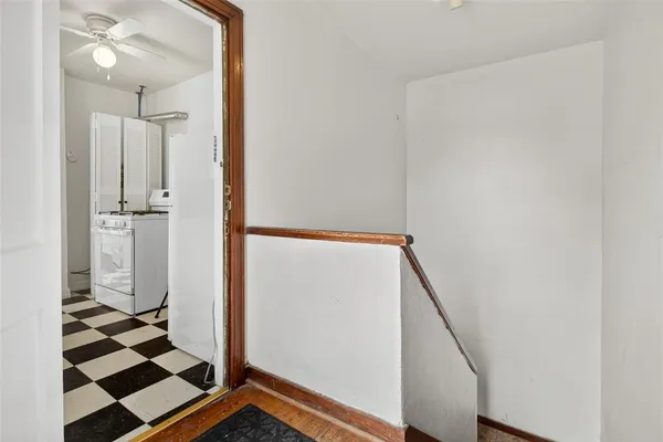 a view of a storage & utility room with a washing machine