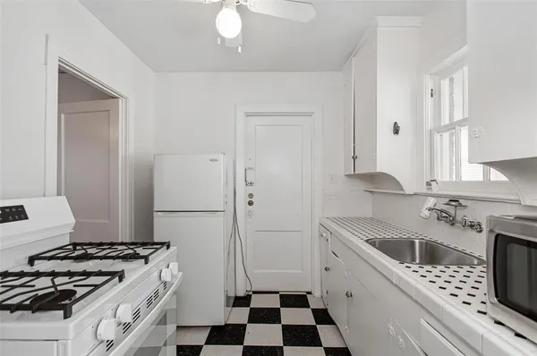 a kitchen with a stove a sink and a refrigerator