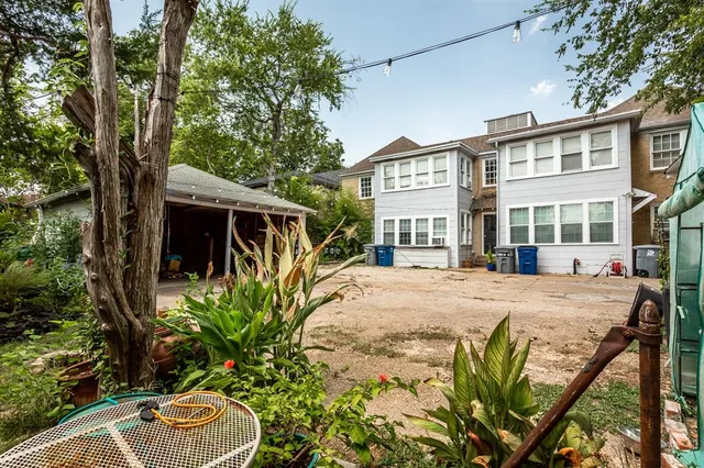 a view of an house with backyard space and sitting area