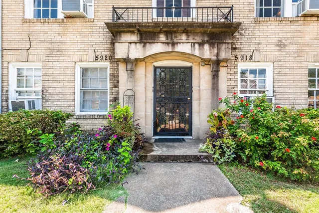 a front view of a house with plants