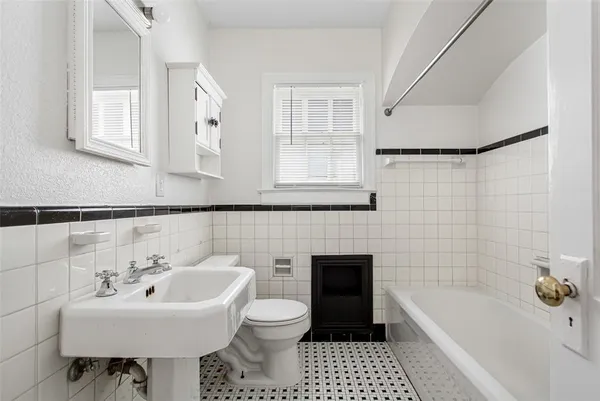 a bathroom with a sink a toilet and bathtub