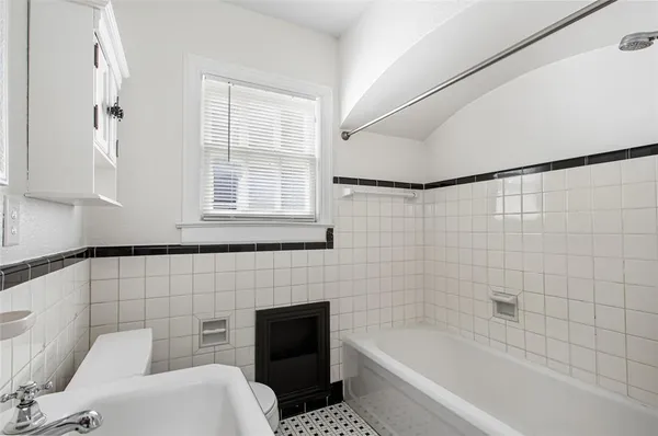 a bathroom with a bathtub and shower