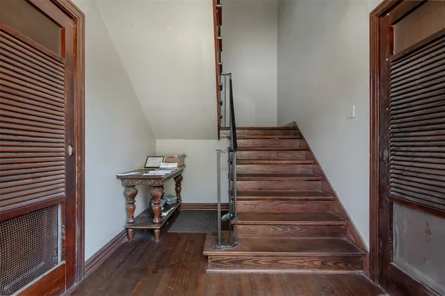 a view of entryway and gallery with wooden floor