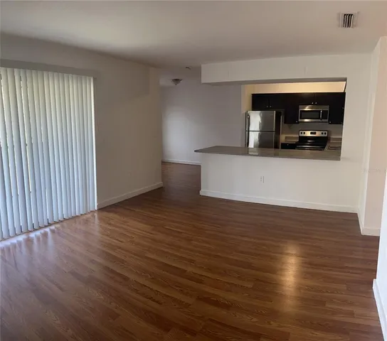 a view of a room with wooden floor