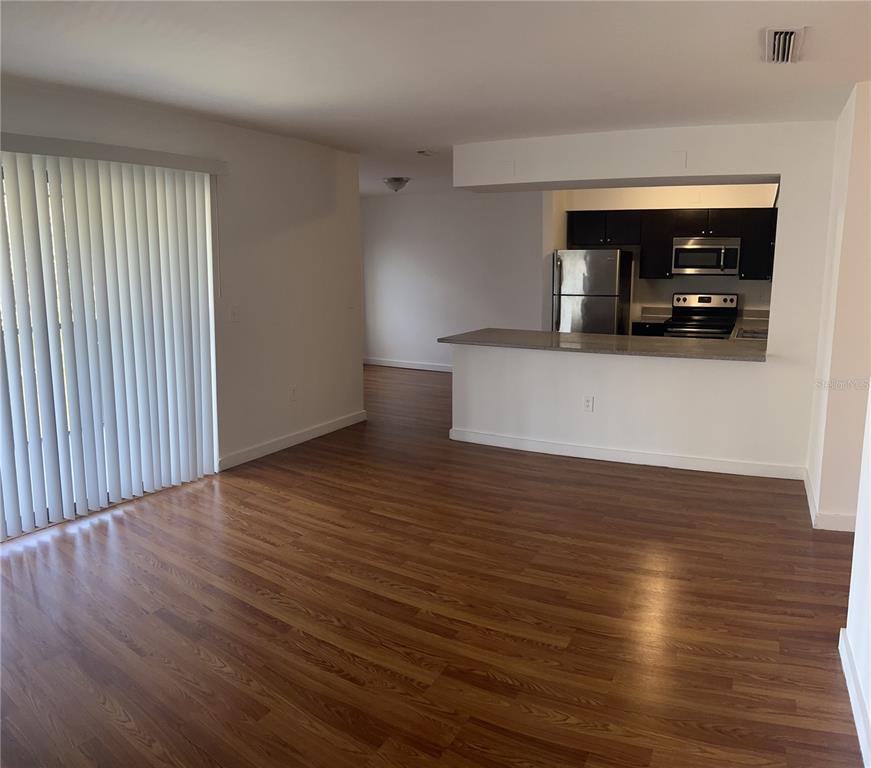 13300 Walsingham Road, Unit 6 Largo, FL 33774 - Photo 2 of 21 a view of a room with wooden floor