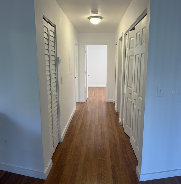 13300 Walsingham Road, Unit 6 Largo, FL 33774 - Photo 4 of 21 a view of a hallway with wooden floor