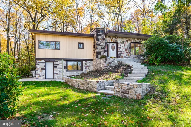 a view of a house with a yard and sitting area