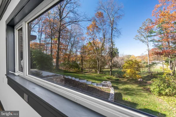 a view of a livingroom with wooden floor and a fireplace