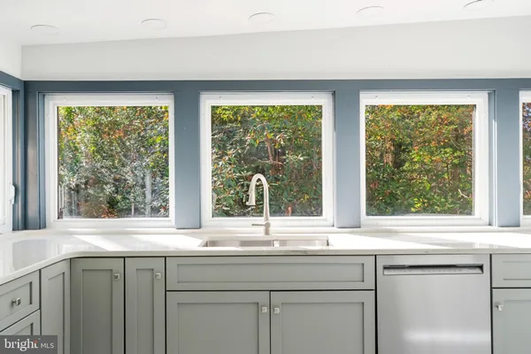 a view of empty room with wooden floor and fireplace