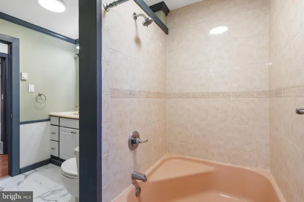 a view of a hallway with wooden floor and a workspace
