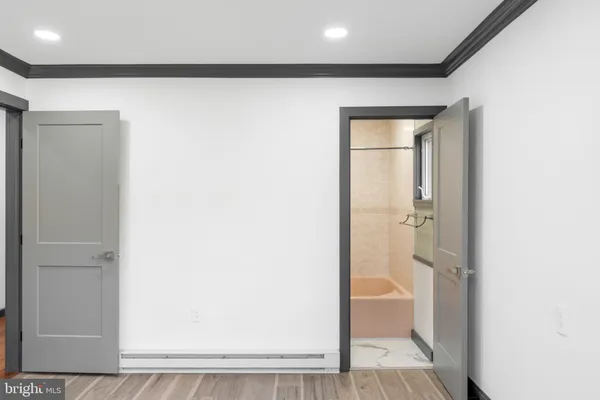 a kitchen with a sink dishwasher and white cabinets