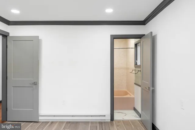 a kitchen with a sink dishwasher and white cabinets