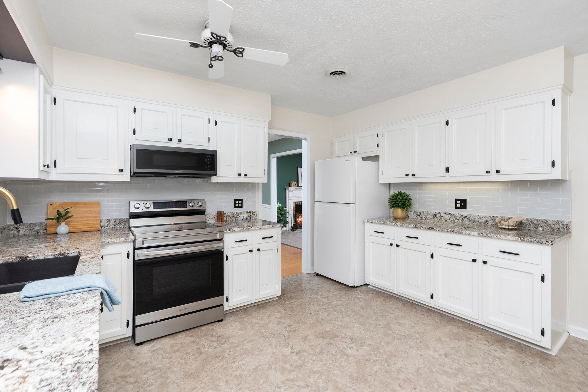 1222 Pinehurst Road Staunton, VA 24401 - Photo 13 of 52 a kitchen with granite countertop a stove a sink and a refrigerator