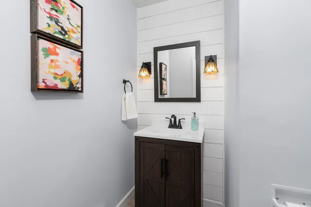 a bathroom with a sink mirror and vanity