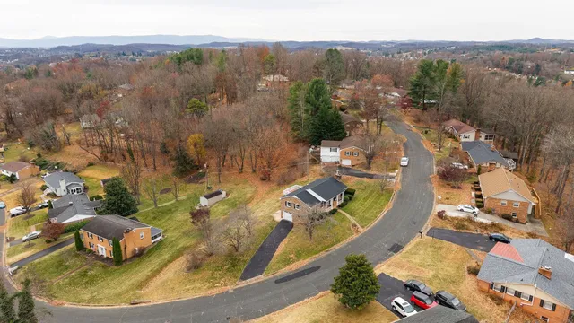 an aerial view of a house with a swimming pool