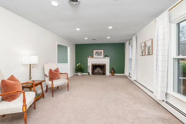 a living room with furniture and a fireplace
