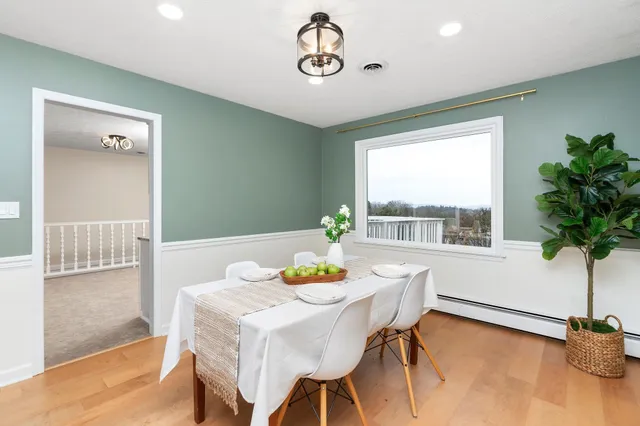 a view of a dining room with furniture window and flowerpot