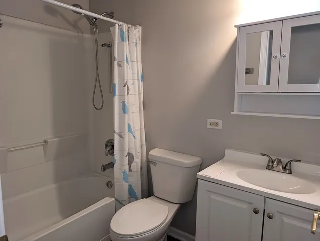 a white toilet sitting next to a bath tub shower