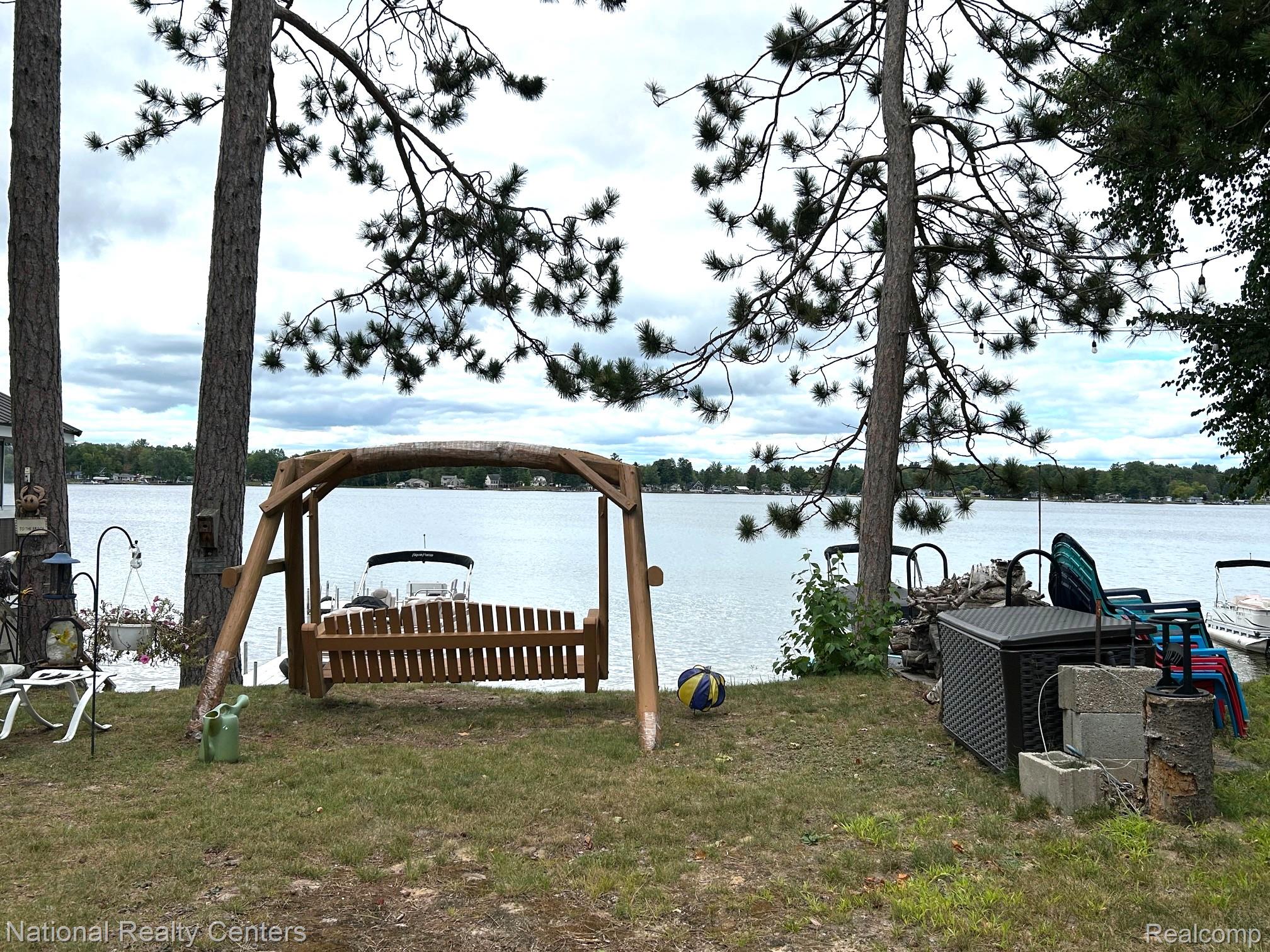 4951 Kokosing Road Hale, MI 48739 - Photo 14 of 37 Dock area featuring a water view and a lawn