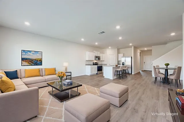 a living room with furniture and wooden floor
