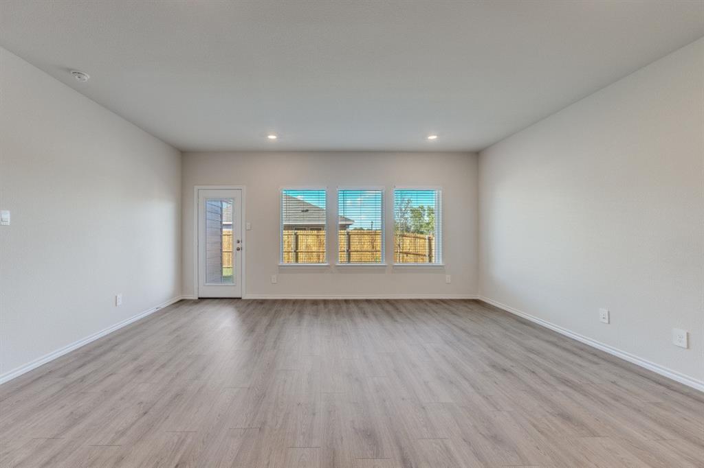 3433 Marie Drive Sherman, TX 75090 - Photo 11 of 39 an empty room with wooden floor and windows
