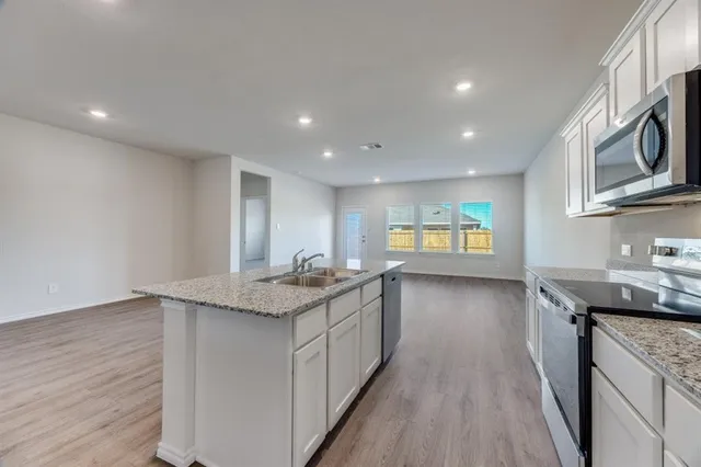 a view of an house with backyard space and garden view