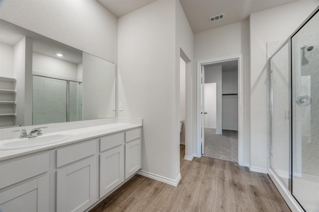 3433 Marie Drive Sherman, TX 75090 - Photo 27 of 39 a spacious bathroom with a double vanity sink and a mirror