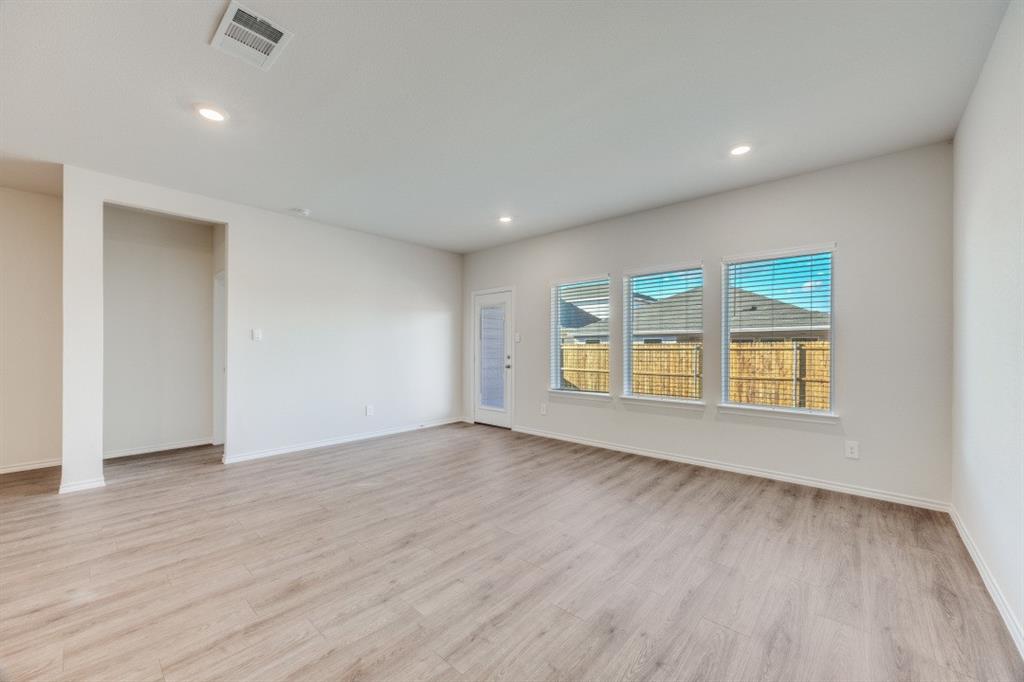 3433 Marie Drive Sherman, TX 75090 - Photo 4 of 39 an empty room with wooden floor and windows