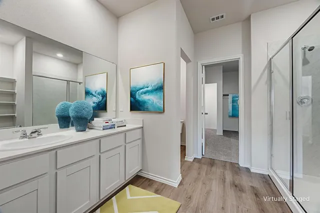 a bathroom with a double vanity sink and mirror