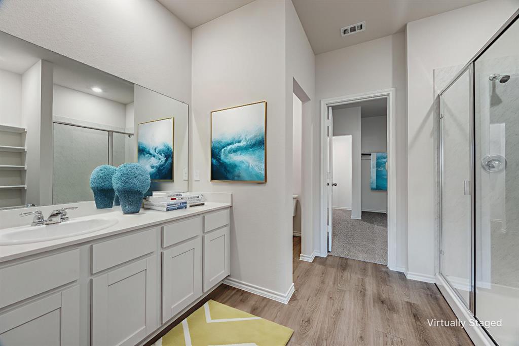 3433 Marie Drive Sherman, TX 75090 - Photo 10 of 39 a bathroom with a double vanity sink and mirror