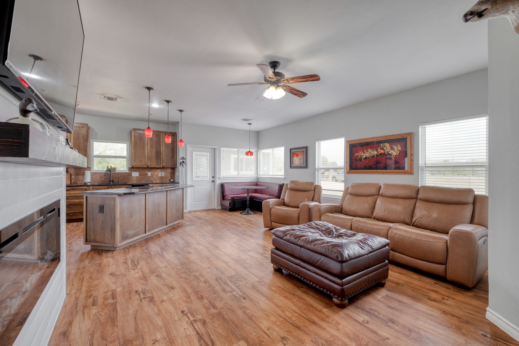2950 County Road 484 Elgin, TX 78621 - Photo 8 of 25 Living area featuring light wood-style floors, ceiling fan, and a fireplace