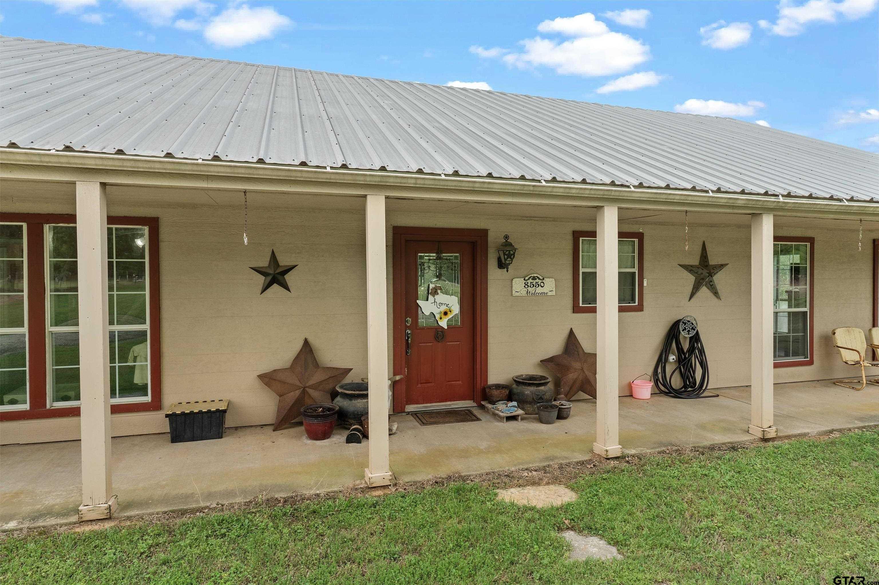 8550 New Hope Road Gilmer, TX 75645 - Photo 2 of 12 a view of a house with yard and sitting area