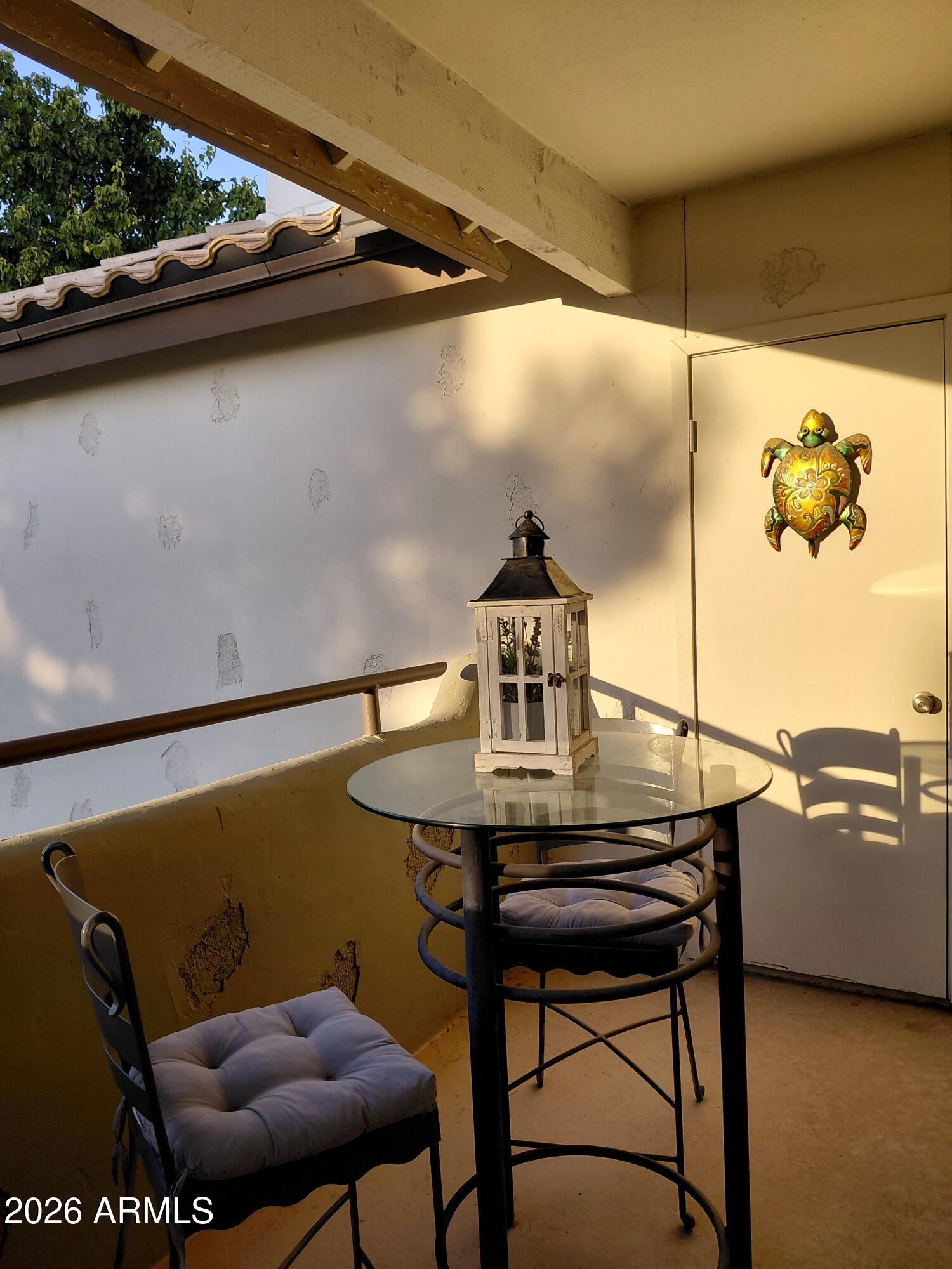 1825 West Ray Road, Unit 2044 Chandler, AZ 85224 - Photo 3 of 14 a view of a chairs and table in the balcony