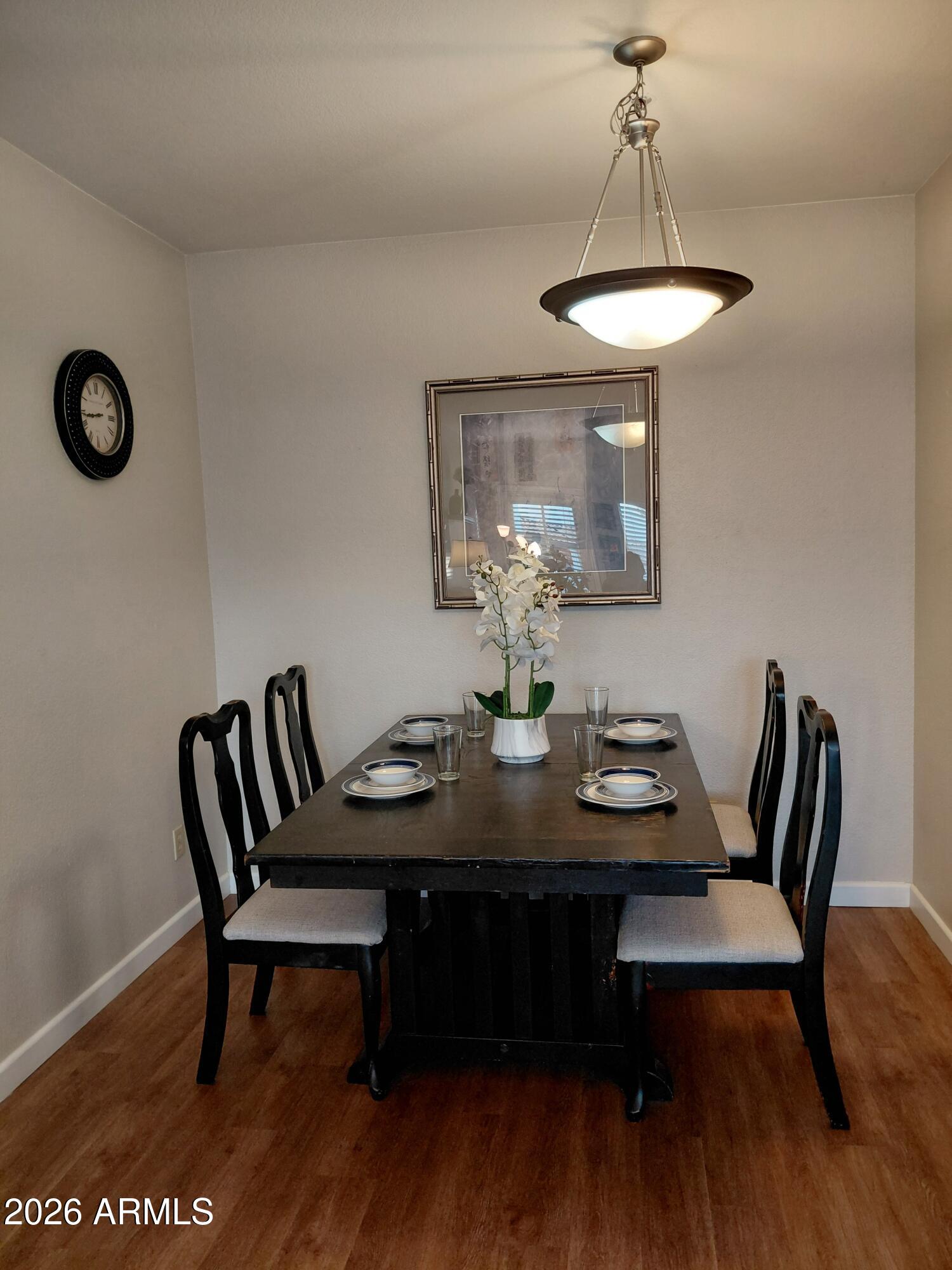1825 West Ray Road, Unit 2044 Chandler, AZ 85224 - Photo 4 of 14 a view of a dining room with furniture and wooden floor