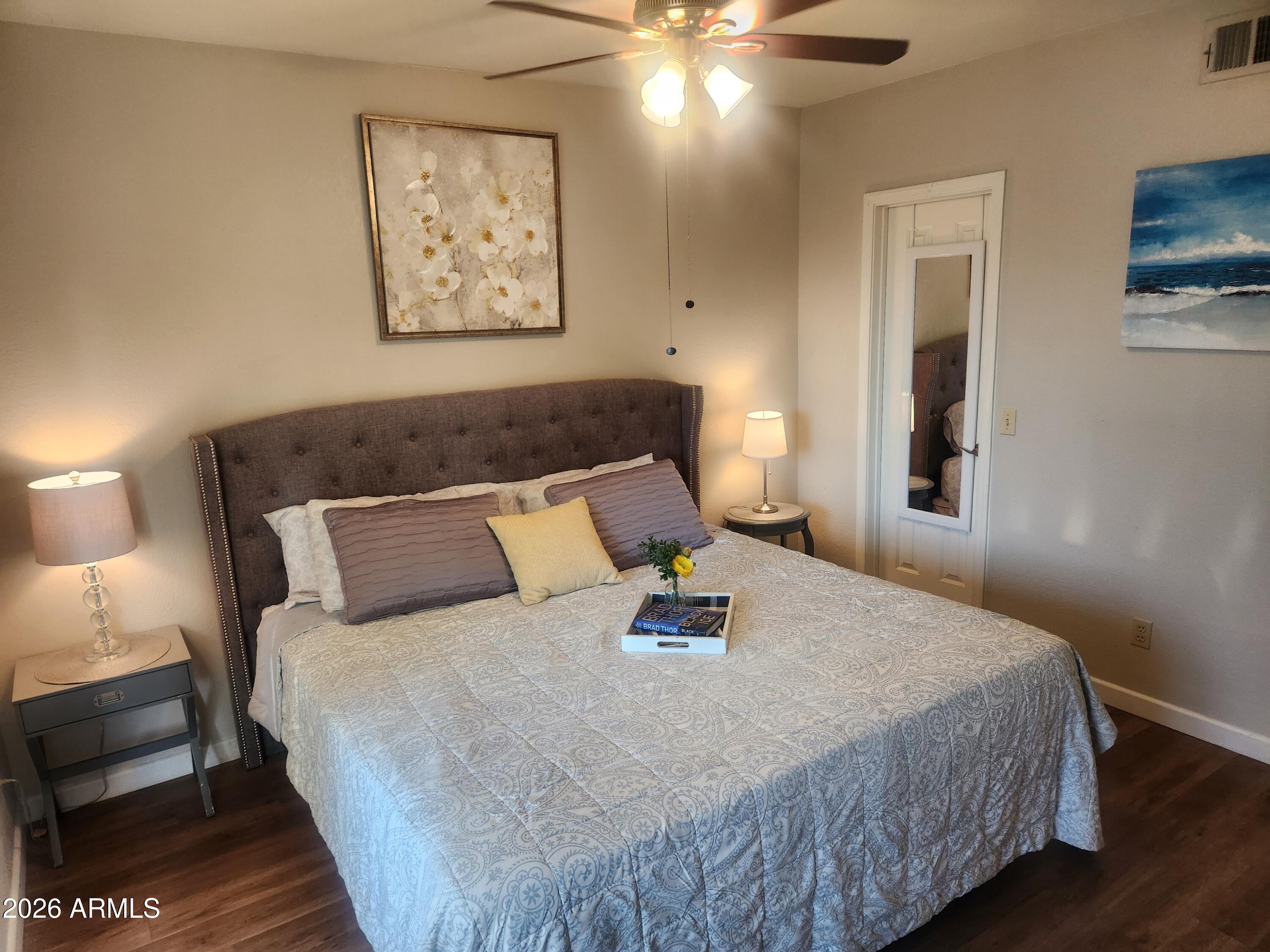 1825 West Ray Road, Unit 2044 Chandler, AZ 85224 - Photo 9 of 14 a bedroom with a bed and a painting on the wall