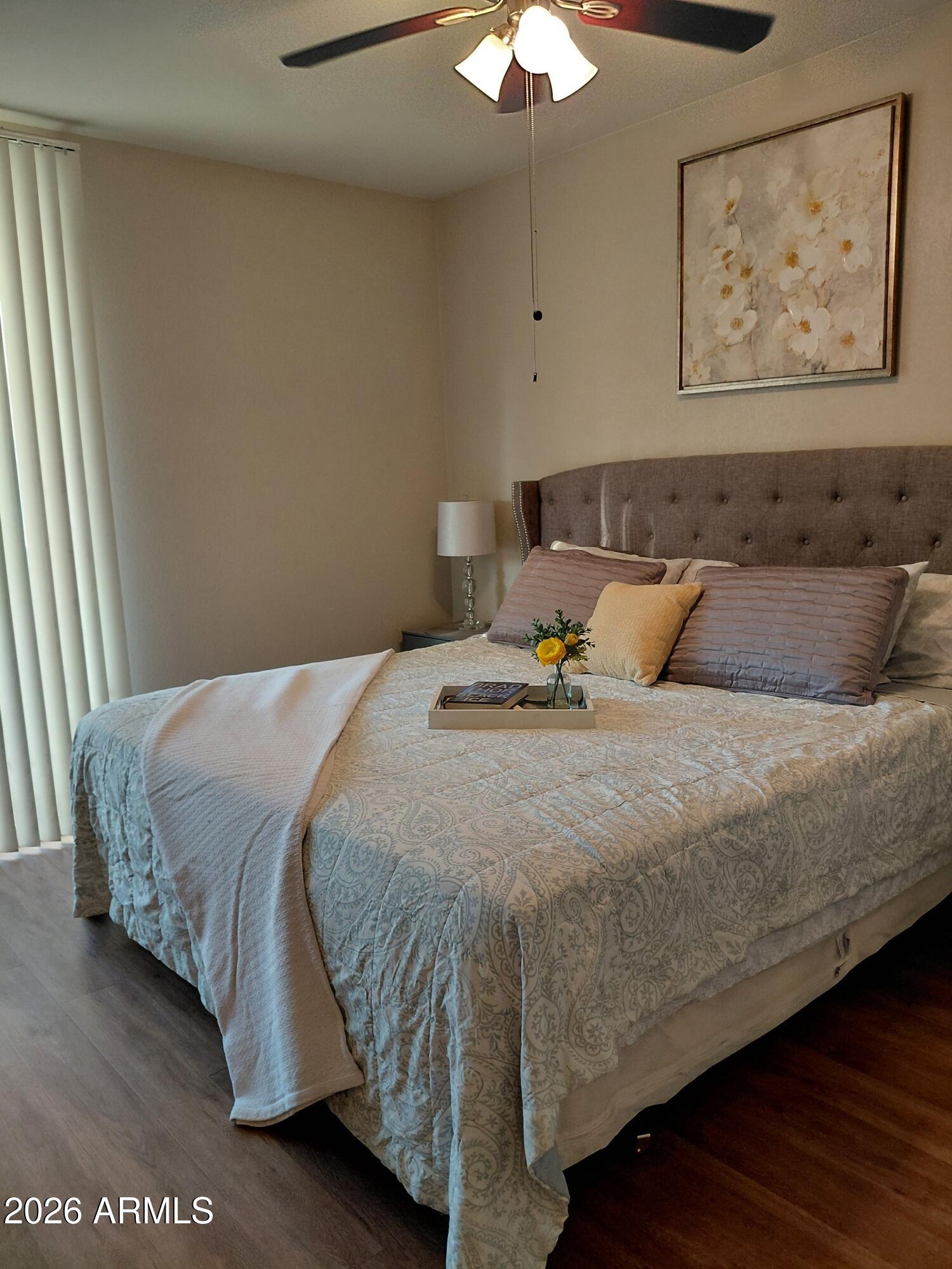 1825 West Ray Road, Unit 2044 Chandler, AZ 85224 - Photo 10 of 14 a bedroom with a bed and a painting on the wall