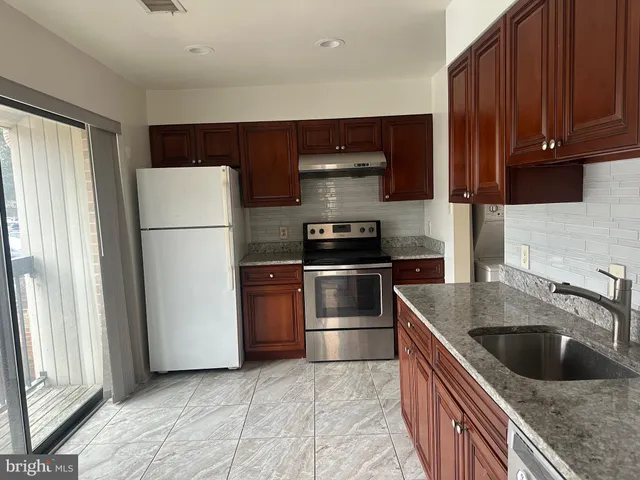 a kitchen with a sink and a refrigerator