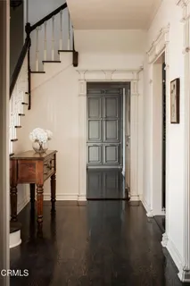 a kitchen with a stove and a wooden floor